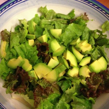 Simple Avocado Salad on a bed of red and green lead lettuce