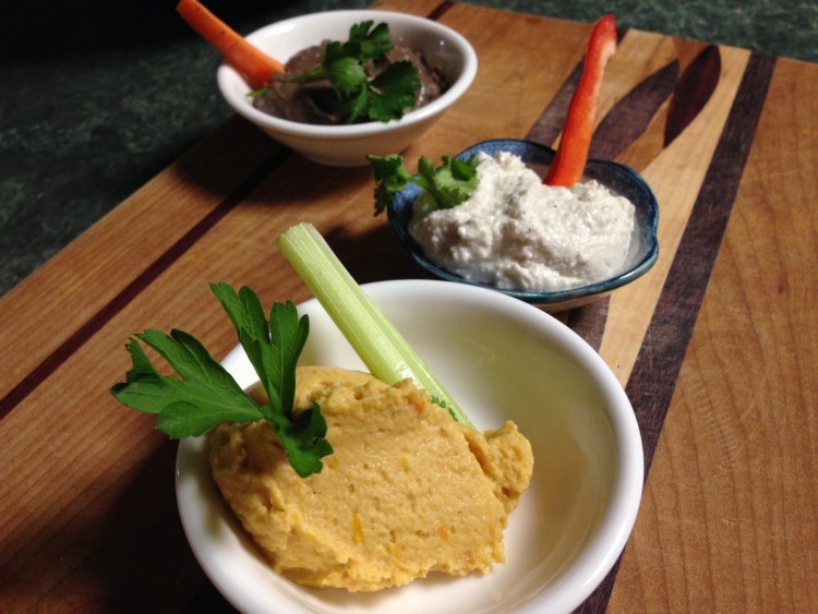 Plate with hummus and garnish of parsley leaf and celery stick